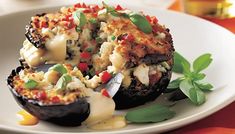 an eggplant stuffed with cheese and vegetables on a plate