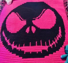 a crocheted blanket with a skull on it