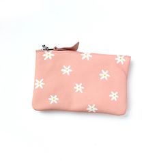 "Elevate your style with our daisy-painted bag! Perfect for an evening out, a grocery run, or simply organizing your cards and cash, this leather pouch is sure to make a fun statement. With two card slots and an unlined interior, you're always ready! These are hand painted and will be completely one of a kind. You will not receive the exact one pictured, there will be small differences in the placement, size and colour. Please allow up to 2 weeks for shipping. Details:  - 100% Genuine leather - Pink Pouch For Daily Use In Spring, Spring Rectangular Coin Purse For Daily Use, Rectangular Coin Purse For Daily Use In Spring, Spring Everyday Use Clutch Pouch, Trendy Wallets For Daily Use In Spring, Spring Pouch Clutch For Daily Use, Spring Rectangular Bags With Interior Card Slots, Spring Bags With Card Slots For Daily Use, Spring Clutch With Zipper Pouch For Daily Use