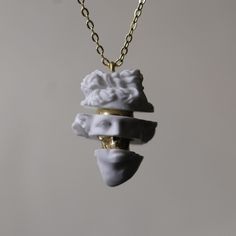 This stunning necklace combines the timeless beauty of classical sculpture with the symbolism of Memento Mori. Handcrafted from marble, the pendant features a fragmented Apollo head with a bronze skull hidden beneath, serving as a powerful reminder of mortality and the passage of time. Perfect for art lovers, history enthusiasts, or those who appreciate unique, meaningful jewelry. The contrast between the smooth marble and the gold accents creates an elegant yet thought-provoking piece. This unique necklace makes an unforgettable gift for art enthusiasts or those with a deep connection to their faith. Whether for special occasions or daily wear, it serves as a lasting symbol of devotion and artistry. This is made with 925 Silver - Bronze And Marble material. Let's not forget that it is han Sculpture Jewelry, Classical Sculpture, Luxury Jewelry Box, Sculptural Jewelry, Deep Connection, Meaningful Jewelry, Skull Pendant, Unique Necklace, Classical Art