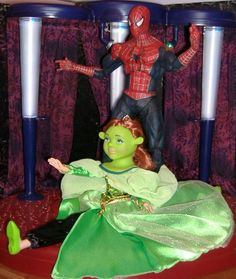 the action figure is being displayed in front of two other toy figurines on display