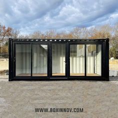 a large black container sitting on top of a dirt field