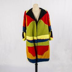 "Fun and colorful vintage stitched fabric oversized coat from the 80s! Beautifully stitched this coat is made with polyester. Goes to around knee level. Has a chain belt loop around waist. Excellent condition, with minimal stain spot near right side waist Measurements Bust: 40\" Waist: 43\" Length: 41.5\" Sweep: 54\" Shoulder to Shoulder: 16.5\" Sleeve Length: 20.5\" Armhole Opening:14\"" Oversized Multicolor Patchwork Outerwear, Retro Oversized Multicolor Outerwear, Oversized Multicolor Long Outerwear, Multicolor Oversized Long Outerwear, Multicolor Long Oversized Outerwear, Oversized Coat, Chain Belt, The 80s, Embroidered Silk