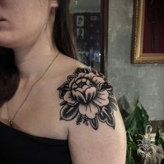 a woman with a flower tattoo on her shoulder