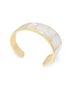 Looking for a new bracelet? The Tenley Gold Shell Cuff Bracelet in Ivory Mother-of-Pearl features an artful silhouette and pieces of shell that have been cut and formed to fit the curvature of the bangle. No matter how you style it, this bracelet is sure to be the star of your stack. Metal 14k Yellow Gold Over Brass Material Tenley Gold Shell Cuff Bracelet in Ivory Mother-of-Pearl Closure Non-Adjustable Size S/M: 2.28" Inner Diameter,1.04"W M/L: 2.48" Inner Diameter, 1.04"WDue to the one-of-a-ki Elegant Jewelry With Oyster Bracelet, Luxury White Mother Of Pearl Bracelets, White Pearl Bracelet With Mother Of Pearl, Elegant Bangle Bracelet In Mother Of Pearl, Mother Of Pearl Bangle Bracelets, Elegant Gold Shell Bracelets, White Polished Cuff Jewelry, Elegant Adjustable Cream Cuff Bracelet, Elegant Cream Cuff Bracelet As Gift