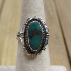 Southwest Vintage Green Turquoise Sterling Silver. The silver work is very nice and add so much to this stone. The turquoise stone is green with a hint of blue and measures approx. 15mm x 8mm. The face of the ring is 22mm x 15mm and the band is 4mm wide. The ring weighs 6g and is a size 6.75. I can offer sizing for an additional fee. Please message me what size you need and I will get back to you with a price. It is stamped sterling and the artists hallmark is NJ. Feel free to ask me questions a Adjustable Green Turquoise Southwestern Ring, Adjustable Green Turquoise Chrysocolla Ring, Southwestern Green Turquoise Ring With Large Stone, Southwestern Style Green Turquoise Ring With Large Stone, Southwestern Green Ring With Large Stone, Southwestern Green Cabochon Rings, Green Turquoise Ring With Natural Stones, Oval Turquoise Chrysocolla Ring In Silver, Oval Silver Chrysocolla Turquoise Ring