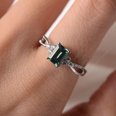 All HANDMADE ITEMS SHIP IN APPROX 8 DAYS Main Stone: Lab created green sapphire Main Stone Size: Emerald cut 5 mm x 7mm Main Stone Weight: 1.16 carat Side Stone: CZs Height From The Ring Setting Bottom(to gemstone top): about 5.05 mm Width of Ring band Measure: gradually varied,about 2.24 to 3.45 mm Material: .925 Sterling Silver/14K White Gold/14K Yellow Gold/14k Rose Gold Engraved: Available For FreeNo more than 13 letters) Customized:Of course! Tell me what you want Includes With Order: All o Silver Emerald Ring With Rectangular Stone For Anniversary, Elegant Sterling Silver Emerald Ring With Rectangular Stone, Elegant Silver Sapphire Ring With Emerald Cut, Emerald Cut Sapphire Ring Gift, Silver Emerald Cut Anniversary Emerald Ring, Elegant Silver Emerald Ring With Rectangular Stone, Gift White Gold Emerald Cut Sapphire Ring, Emerald Cut Sapphire Jewelry For May Birthstone, Emerald-cut Sapphire Jewelry For May Birthstone