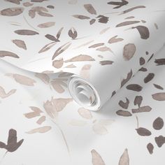 a white and brown wallpaper with leaves pattern on it's back droplet