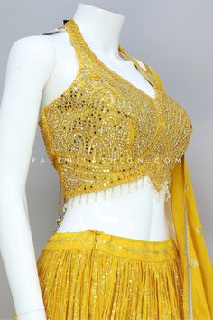 Wear a light yellow lehenga choli from palkhi fashion, Where tradition meets contemporary charm. Lehenga is highlighted with full flair, pure georgette fabric, petite sequin embroidery, and threadwork. The matching halter neck blouse is enriched with mirror work, pearl, kundan, and handwork. It comes with a full-length pure georgette dupatta crafted with thread embroidery, and sequins work, which add extra charm. Light Yellow Lehenga, Latest Haldi Outfits, Halter Neck Blouse Design, Yellow Blouse Designs, Yellow Lehenga Choli, Palkhi Fashion, Halter Neck Blouse, Halter Neck Blouses, Haldi Outfits