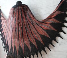 Large feather shawl is hand knitted from black and red melange or yellow and grey wool blend. This wool shoulder wrap has length  about 39,3" (100cm) and width about 86,6" (220cm) You can wear this bird wings shawl as a bridal cape on Boho wedding or as a shoulder wrap with festive dress and shawl wrap for the evening walks.  This wingspan hand knit shawl is ready to despatch in gift wrapping, it can be great gift for wife, anniversary gift or Mother day gift. Any woman will be happy to receive Feather Shawl, Festive Dress, Hand Knit Shawl, Large Feathers, Knit Shawl, Shoulder Wrap, Bird Wings, Bridal Cape, Evening Walk