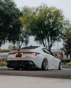 a white car is parked on the street