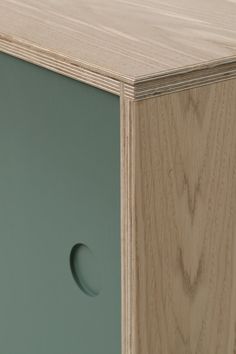 a close up of a wooden cabinet with an oval hole in the front and bottom