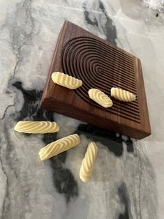 four slices of bread on a wooden cutting board next to it's grater