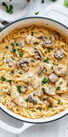 a pan filled with pasta covered in mushroom sauce