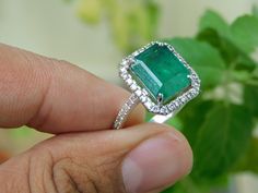 This is a perfect Engagement gift, Anniversary gift, Wedding gift, Mothers Day gift, Birthday gift, Holiday gift or an I Love You gift!! - Natural Conflict-Free Diamonds - Comfortable Band gem type- zambian emerald gem color- green weight- 4.70 carat size - 8.20 mm width and 11.40 mm length emerald cut - very good shape- heart orgin- zambian quality diamonds use around the ring material- 14k solid gold high quality Australian diamonds used color - h pure white clarity -si1-si2 weight - 0.70 cara Emerald And Diamond Engagement Ring, Perfect Engagement Gifts, Engagement Ring Women, Natural Emerald Rings, Emerald Gem, Zambian Emerald, Gold Gift, Ring Women, Gift Ring