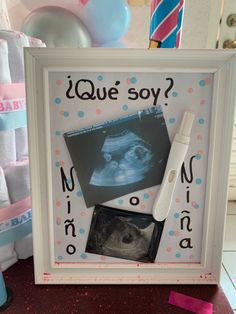 there is a picture frame with baby pictures and a toothbrush in front of it