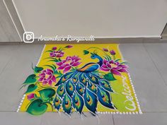 a colorful rug with a peacock and flowers on the floor in front of a door