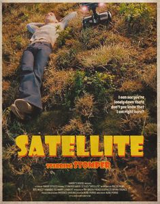 a movie poster for satellite featuring a man laying on the ground