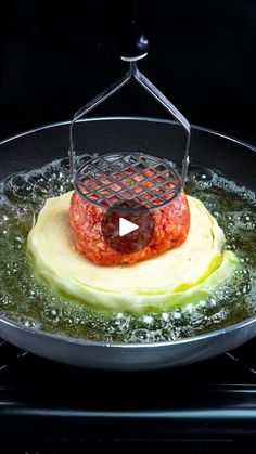 a frying pan with some food in it on top of an oven burner