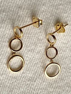 14K solid Gold Dangle circles Earrings Colombian art Earrings Details Metal: 14k Yellow Gold Height: 20 mm  Width: 7 mm - A good investment since 14k solid gold items hardly go down in value and in fact would go up in value long term. * It's a very flattering minimalist earring perfect for any occasion. Packing Each order will be beautifully packaged for gift giving in a jewelry box. 14k Yellow Gold Circle Earrings, 14k Gold Circular Earrings, Tarnish Resistant Yellow Gold Circle Earrings, 14k Gold Round Earrings, Modern 14k Gold Circle Earrings, Yellow Gold Circle Earrings, Yellow Gold Circle Earrings For Anniversary, Yellow Gold Circular Anniversary Earrings, Yellow Gold Circle Earrings For Formal Occasions