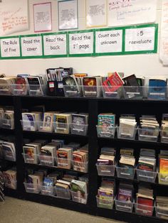 a book shelf filled with lots of books on top of it's sides and plastic bins