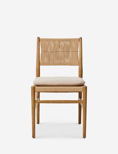 a wooden chair with a beige seat and back cushion on the side, against a white background