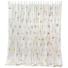 the sheer curtain is decorated with flowers