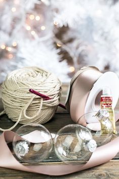 two balls of twine are sitting on a table next to some yarn and scissors