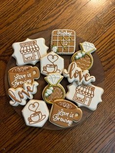 some cookies are on a plate with writing and pictures around them that say love is brewing