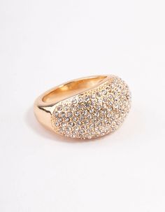 a gold ring with lots of small white stones on it's side, sitting on a white surface