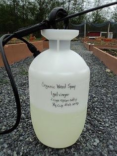 a white propane bottle sitting on top of gravel