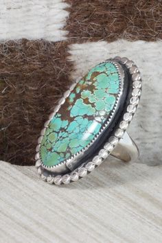 This turquoise and sterling silver ring was made by Navajo silversmith Priscilla Reeder. The back is signed PR and stamped sterling.Size: 9.5Length: 1 3/4"Width: 1 1/8"Free shipping on all orders! We ship with USPS and always include tracking. All orders ship within a day of payment.Returns are accepted up to 30 days after you receive your order. Just send us a message. Our shop offers cash back or store credit. The item must be returned in new condition. Western Green Turquoise Ring In Sterling Silver, Western Sterling Silver Turquoise Ring With Patina, Western Oval Turquoise Ring With Inlay, Western Style Oval Turquoise Ring With Inlay, Western Style Oval Turquoise Inlay Ring, Western Turquoise Ring With Inlay, Western Style Turquoise Ring With Inlay, Western Style Untreated Oval Turquoise Ring, Oval Turquoise Ring With Sterling Silver Inlay