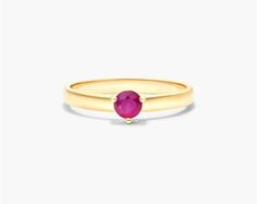 The 14K Yellow Gold 2.3mm Ruby Solitaire Birthstone Ring is a stunning and elegant piece of jewelry that is perfect for any occasion. The ring features a fiery ruby gemstone that is set in a 14K yellow gold band. Ruby is the birthstone for July, and it is known for its beauty and symbolism of love, passion, and romance. This ring is the perfect way to add a touch of color and sparkle to your look. The ring is made of high-quality materials that will last for years to come. The ruby is a natural Formal Yellow Gold Ruby Ring With Round Stone, Classic Ruby Birthstone Ring With Round Band, Classic Yellow Gold Ruby Ring With Birthstone, Ruby Birthstone Ring In Yellow Gold With Prong Setting, Yellow Gold Ruby Ring Birthstone, Yellow Gold Ruby Ring Birthstone With Round Cut, Classic Ruby Birthstone Ring With Round Cut, Yellow Gold Ruby Birthstone Ring With Round Band, Classic Ruby Birthstone Ring Round Cut