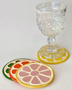 two glass goblets sitting next to each other on top of a white table