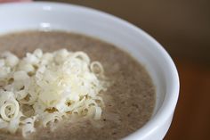 a close up of a bowl of soup with some type of food on top of it