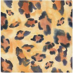 an animal print fabric with brown and black spots on yellow, orange and blue colors