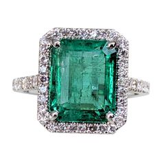 Ring can be resized free of charge prior to shipping out. Ring Size: 56 EU Center Natural Emerald: Weight: 6.48 ct Color: Green Shape: Emerald *Emeralds are commonly enhanced by oiling as part of their normal fashioning process, significant enhancement present Side Stone Diamonds: Weight: 0.62 ct / 46 stones Color: Near Colorless (G - H, To Faint Pink) Clarity: I1-I2 Shape: Round Brilliant Item ships from Israeli Diamonds Exchange, customers are responsible for any local customs or VAT fees that might apply to the purchase. **Import duties and taxes are not included in the item price. The Import process is very simple as the shipping company does the entire import procedure. All the customer has to do is pay the VAT and customs clearance. ** In Hong Kong and the USA the VAT is 0%. ** High Modern Wedding Rings, Diamond Mines, Pink Diamonds, Modern Ring, Customs Clearance, White Gold Ring, Natural Emerald, Pink Diamond, Modern Jewelry