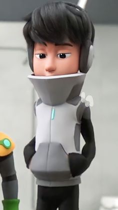 an action figure with headphones on standing next to another character in front of a mirror