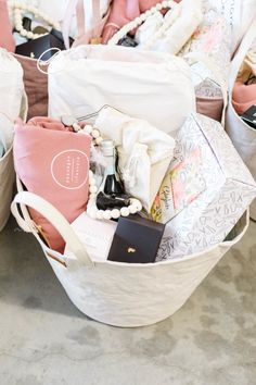 several baskets filled with personal items on top of a floor next to bags and purses