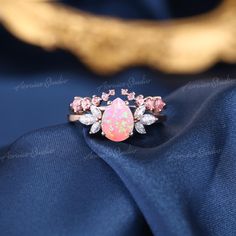 Unique Pink Fire Opal Engagement Ring Set Women Rose Gold Lovely Pink Opal Wedding Ring Pink Sapphire Wedding Band Custom Rings For Women Jewelry Information: ♡ Handmade, high-quality item ♡ Material: SOLID 14K/18K GOLD ( can be made in yellow/white/rose gold ) ♡ Engagement ring ♡ Center stone: Lab Pink Fire Opal ♡ Size/Weight:  6x8mm  ♡ Cut - Pear Shaped ♡ Color: Pink ♡ Side stones: Moissanite/ Natural diamonds ♡ Weight:  About 0.28 ct ♡ Cut - Marquise Shaped ♡ Clarity - SI-VS ♡ Color- G-H ♡ Ba Wedding Ring Pink, Pink Sapphire Wedding Band, Wedding Rings Pink Sapphire, Fire Opal Engagement Ring, Opal Wedding Ring, Pink Opal Ring, Opal Engagement Ring Set, Pink Fire, Opal Engagement Ring