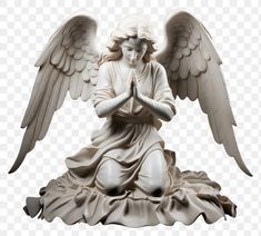 an angel statue sitting on top of a white ground with its hands folded in prayer