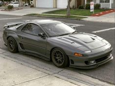 a gray sports car parked on the side of the road