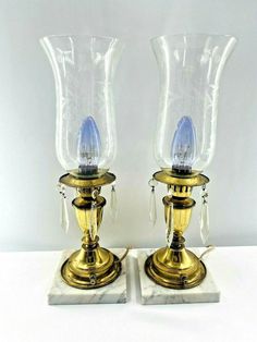 Set of 2 Hollywood Regency MCM Etched Hurricane Candle Lamps Brass Colored on Marble Base With with 4 Glass Prisms each Measures Approx. 16" x 5" Vintage condition with crazing of brass color and one glass shade has minor chipping on edge see pics Preowned Condition- See Pics- Auction, Estate Sale Finds, or Vintage Store Buys - Sold As-Is-SEE PICS We describe as best as we can and take as many photos as possible. All photos are of the actual item and are an essential part of the description. Many of our items are vintage, Preowned, or from Auction, Estate Sales, and may have some minor scuffs or wear from use or minor package flaws. Please check all photos carefully Flower Vase Design, Blue Flower Vase, Candle Lamps, Metal Tree, Estate Sale Finds, Crystal Bowls, Glass Photo, Prisms, Hollywood Regency