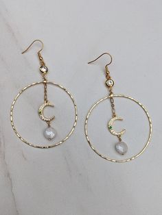 Large 18k Gold Plated Hoop Earrings w/ Gold CZ Connector, Micro Pave Moon Charm, and Wire Wrapped Faceted Moonstone Bead, Statement Earrings Beautiful gold hoops with cubic zirconia and micro pave evil eye connectors and green jade hand-wire-wrapped dangle earrings. These Boho-style earrings are absolutely stunning! They're fun, versatile, and perfect for adding unique style to any outfit. The moon, a feminine symbol, universally represents the rhythm of time. It embodies the cycle of transition in life, making these earrings not just a fashion statement but a symbol of life's journey. These 18k gold-plated 50mm hoop earrings are 3 inches from the top of the earring to the bottom hoop and gold-plated ear wires (gold-filled ear wires are available for an additional $6.00 - please message me Celestial Hoop Earrings With Moon Charm, Celestial Round Hoop Earrings With Moon Charm, Gold Celestial Crystal Earrings With Moon Charm, Gold Moon-shaped Celestial Crystal Earrings, Celestial Gold Moon-shaped Crystal Earrings, Metal Hoop Earrings With Moon Charm, Round Metal Hoop Earrings With Moon Charm, Gold Dangle Crystal Earrings With Moon Charm, Gold Moon Hoop Earrings