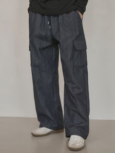 Editor's notesIt is a casual denim pant in non-fade denim fabric that has texture and mood of raw denim but does not bleed. The elastic band on the waist and cargo flap pockets on each side make comfy fit and trendy design. The pant is finished without a washing process so that it does not have any harmful residue on the surface.- Relaxed straight fit- Patch flap pockets- Side pockets- Back pocketMeasurements(in.)M / L- Length: 40.6 in. / 41.1 in.- Waist: 12 in. / 12.8 in.- Hip: 19.3 in. / 20.5 in.- Thigh: 11.8 in. / 12.6 in.- Hem: 9.4 in. / 10 in.- Rise: 13.8 in. / 14.4 in.*Model info: Height 6’ 2” / Fitting size: Size LComposition & Care- 65% Cotton, 35% Polyester- Dry clean recommended- Wash in cold water- Avoid tumble dryDesigner- by WEDNESDAY OASIS Baggy Indigo Jeans With Pockets, Urban Dark Wash Pants With Pockets, Urban Style Dark Wash Bottoms With Cargo Pockets, Urban Dark Wash Bottoms With Cargo Pockets, Utility Wide Leg Recycled Denim Bottoms, Utility Wide-leg Recycled Denim Bottoms, Wide Leg Utility Bottoms In Recycled Denim, Casual Washed Blue Cargo Pants With Patch Pockets, Urban Style Dark Wash Cargo Pants With Hip Pockets