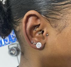 a woman with two piercings on her ear