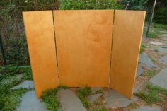 a wooden screen sitting on top of a stone walkway