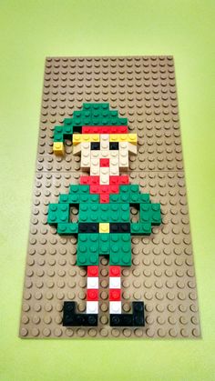 a lego christmas elf is standing on the floor