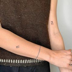 a woman's arm with the word love tattooed on it, and an arrow