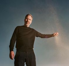 Director Denis Villeneuve stands dressed in black against a blue sky letting sand spill from his hand The Messiah, Mens Long Sleeve, Long Sleeve Tshirt Men, Long Sleeve Tshirt, Normcore, Mens Tops, Mens Tshirts, Long Sleeve, T Shirt